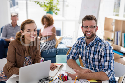 Male and female executives working together in the office