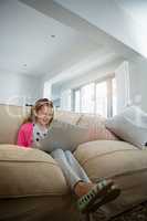 Girl using laptop in the living room