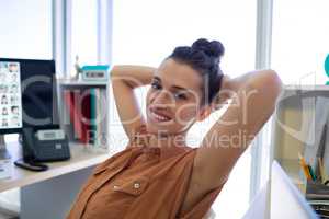 Female executive relaxing at her desk