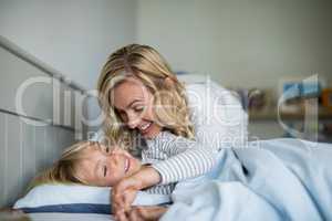 Mother and son having fun together in the bedroom