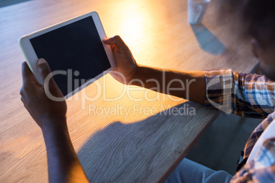 Male executive using digital tablet at his desk