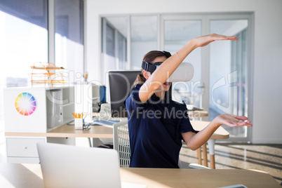 Female executive using virtual reality headset