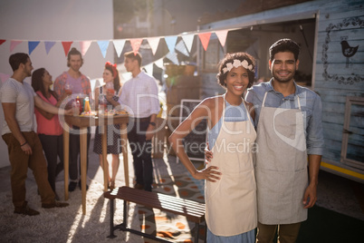 Portrait of happy waiter and waitress