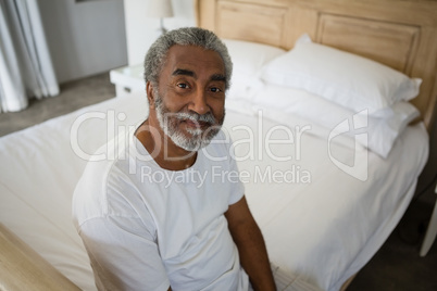 Senior man relaxing on bed at home