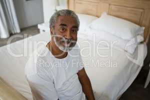 Senior man relaxing on bed at home