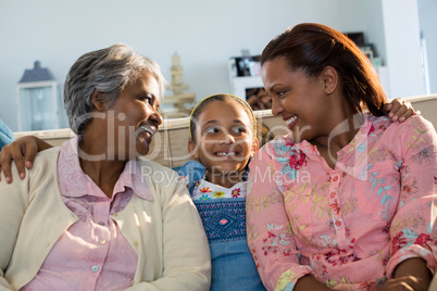 Happy family sitting on sofa in living room