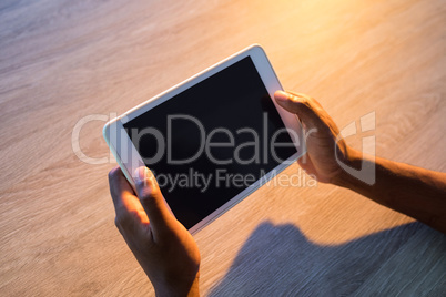 Male executive using digital tablet at his desk