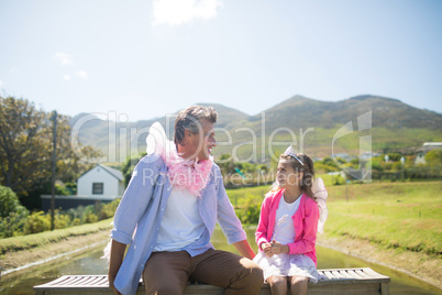 Daughter and father in fairy costume interacting with each other