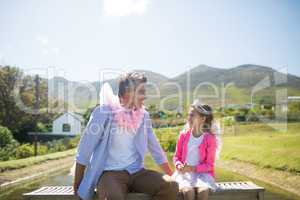 Daughter and father in fairy costume interacting with each other