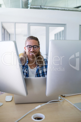 Male executive working over laptop at his desk
