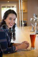Portrait of happy beautiful woman at bar