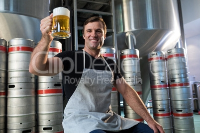 Portrait of smiling worker holding beer glass