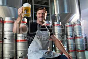Portrait of smiling worker holding beer glass