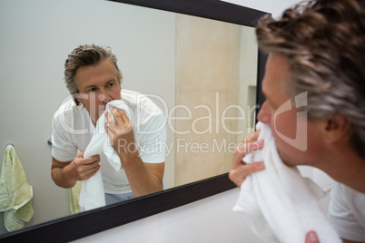 Man wiping his face with towel