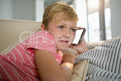 Boy talking on mobile phone in the living room