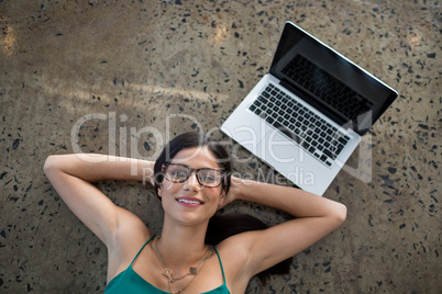 Portrait of female executive lying on the floor