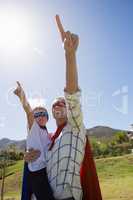 Mother and son pretending to be superhero in the backyard