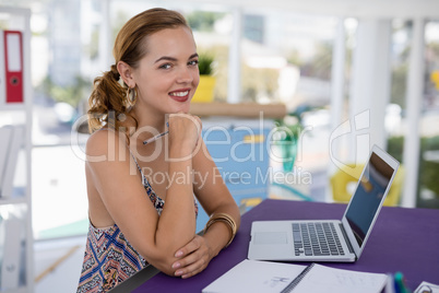 Portrait of female executive at desk in the office