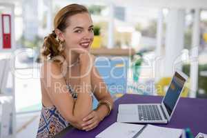 Portrait of female executive at desk in the office