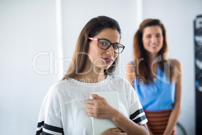 Female executive in spectacle standing in office