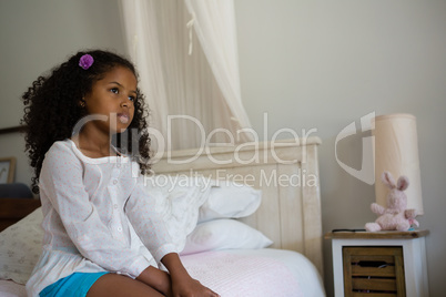 Girl sitting on bed in the bedroom at home