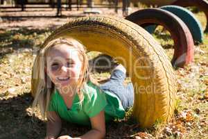 Portrait of happy girl playing with tire