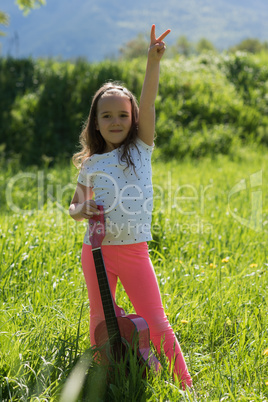 Portrait of cute girl gesturing while holding guitar