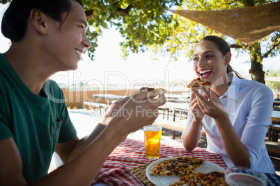 Happy friends having pizza