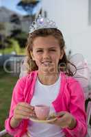 Girl in fairy costume holding coffee cup
