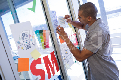 Male executive writing on sticky notes