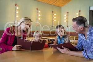Family reading menu in restaurant