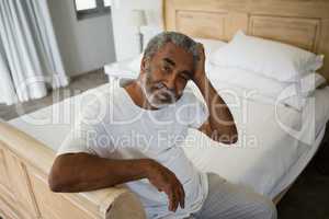 Senior man relaxing on bed at home