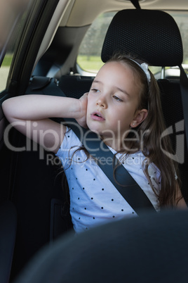 Girl sitting in back seat of car