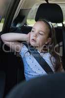 Girl sitting in back seat of car
