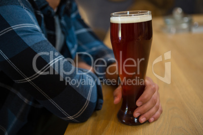 Midsection of man with beer glass