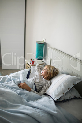 Boy relaxing on bed in the bedroom at home