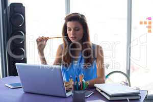 Female executive working over laptop