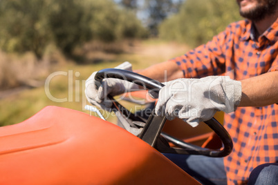 Man driving tractor in olive farm