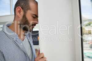 Frustrated designer leaning on wall