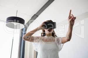 Businesswoman using virtual reality simulator in office