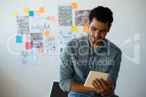 Man using tablet against adhesive notes at office