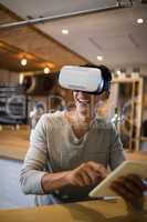 Man using virtual reality headset and digital tablet in restaurant