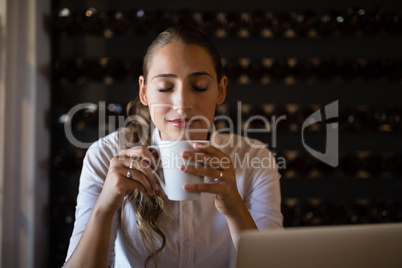 Smiling woman having coffee in cafe