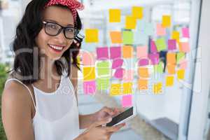 Smiling female executive using mobile phone