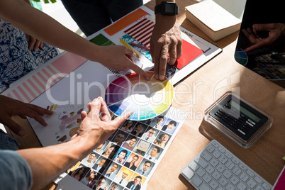 Team of graphic designers discussing over document