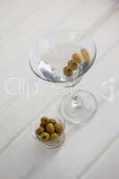 High angle view of olives in container by vodka martini