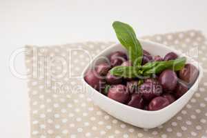 High angle view of brown olives with herb