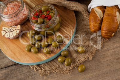High angle view of olives and spice on cutting board