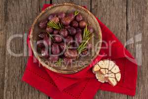 Overhead view of olives with rosemary in bowl