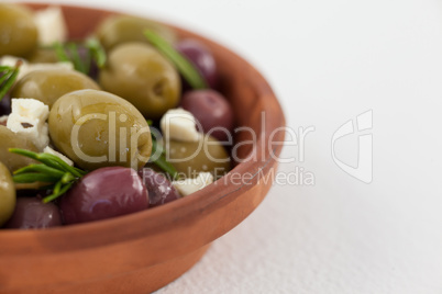 Cropped image of olives with cheese served in bowl